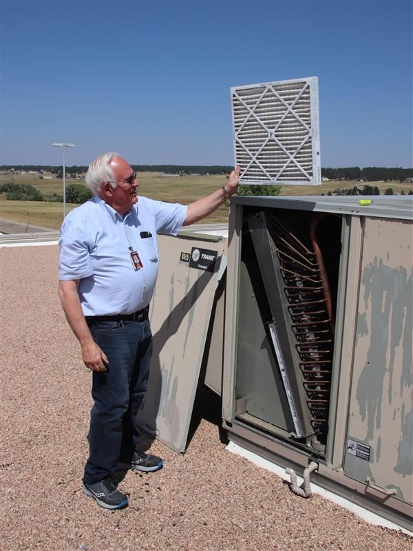 Larry Lorimer inspects a MERV-13 filter on the roof of EHS.